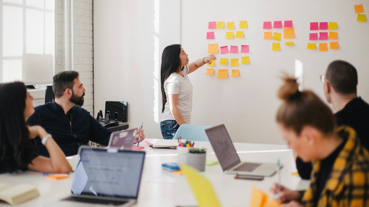 Corporate instructional designer and IT architect configuring multi-tenant Enterprise LMS permissions and SCORM xAPI analytics
